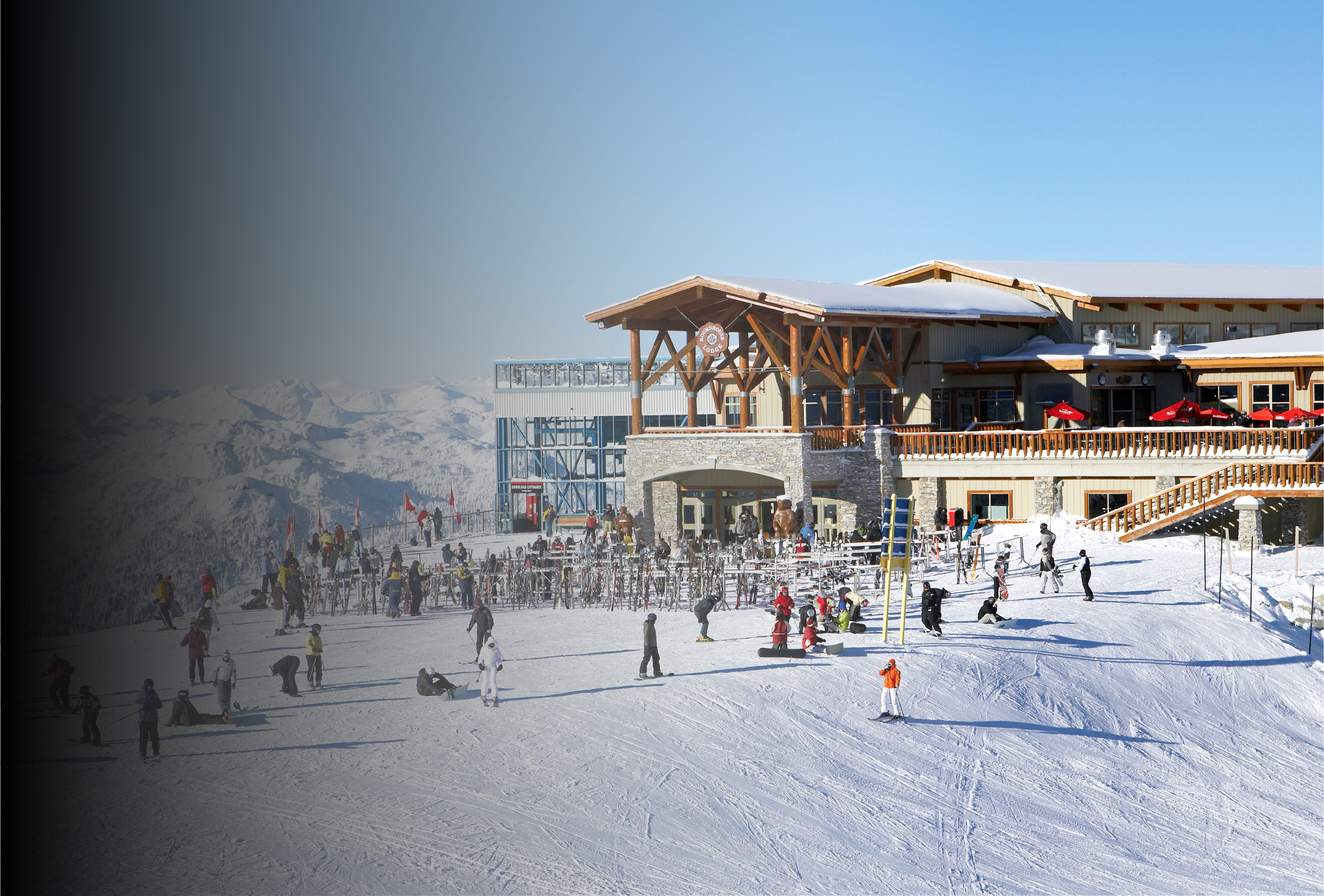 Ski resort main lodge exterior busting with skiers and snowboarders